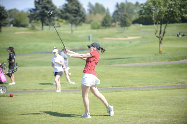 Camas senior Emma Cox drives the ball down the center of the fairway on hole number 18 at Tri-Mountain Golf Course in Ridgefield during day one of the district tournament on May 6.