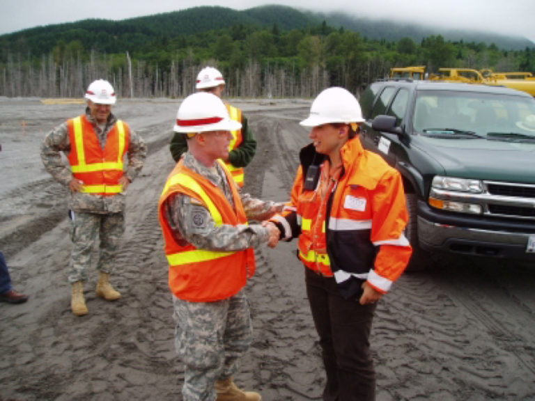 Kim Erion (right), president of LKE Corporation, a Washougal-based construction company that specializes in environmental restoration work, shakes the hand of Major General Merdith W.B. Temple from Washington D.C., at the Toutle River construction site on Mount St. Helens. (Contributed photo by K.