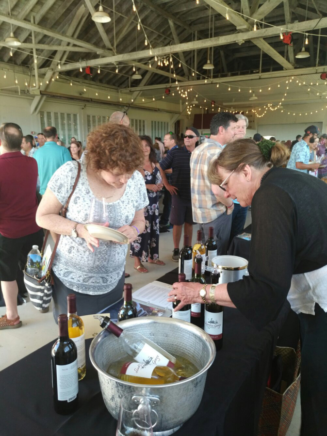 Cheryl Hall (right) talks about her family&#039;s Washougal-based winery, Columbia Gorge Vintners, at the Savor Southwest Washington Wines event held May 11 at the historic Pearson Air Museum in Vancouver.