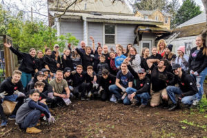 A group of volunteers from Acts Church Camas and Vancouver-based Flash Love celebrate after completing yard work at the home of Camas resident Debbie Nichols (holding dog) on April 19. (Contributed photo by Todd Roy)