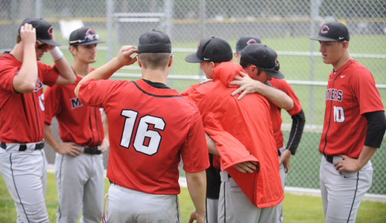 Camas head coach Stephen Short consoles his players moments after being knocked out of the state playoffs by Issaquah.