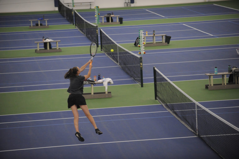 Washougal senior Beyonce Bea goes airborne, using two hands for a winning point at the net during the 2A district tournament on May 16.