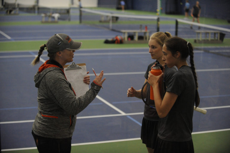 Head Washougal tennis coach Angela Watts consults with Emily Johnson (center) and Elise Moore (right).