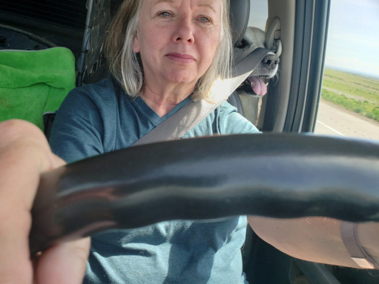 Kathy Blank of Washougal drives cross-country with her dog, Gracie, resting her head on her shoulder.