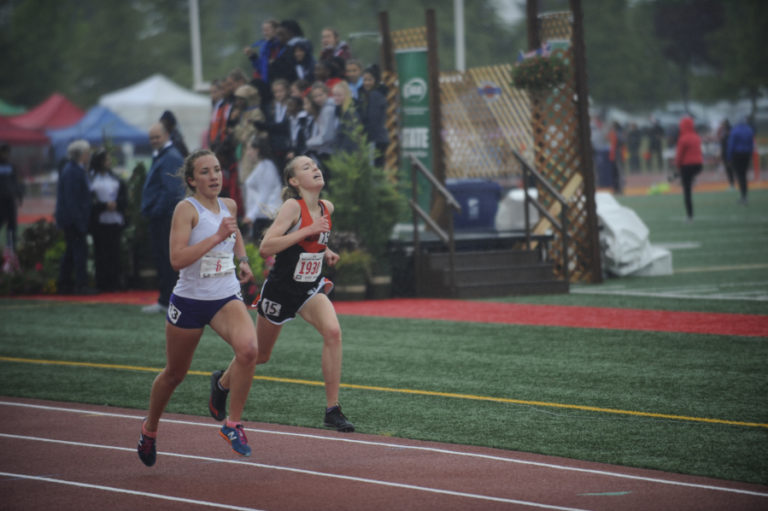 Washougal High senior and valedictorian Amelia Pullen (right) charges for the finish line in the finish line in the state finals of the 3,200 meters finishing fourth.