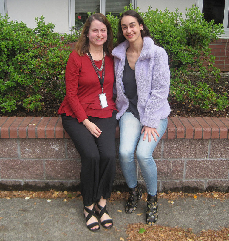 Camas School District employee Lyn Garcia (left) and her daughter, Catherine, sit outside Camas High School.
