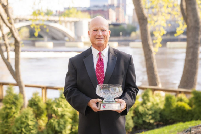 Camas native Rod Morasch holds the teaching award he received at a national awards ceremony in Minneapolis from the United States Tennis Association.