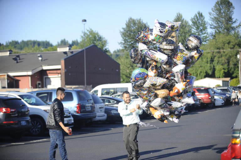 A visitor carries a giant cluster of balloons to the June 8 Washougal High School class of 2019 graduation ceremony on June 8.