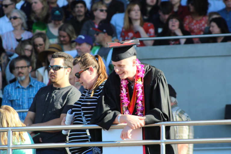(Photo by Kelly Moyer/Post-Record)
A Camas High School class of 2019 graduate leans over the railing at Doc Harris Stadium in Camas before their graduation ceremony on June 14.