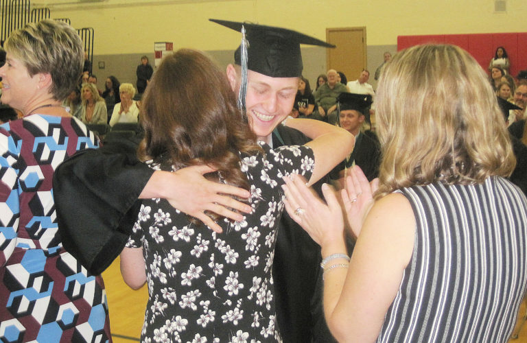(Photo by Doug Flanagan/Post-Record)
Hayes Freedom High School class of 2019 graduate Dillon Giel-Newberry hugs secretary D.J. Johnson after receiving his diploma June 15 at a Hayes Freedom graduation ceremony held at Liberty Middle School.