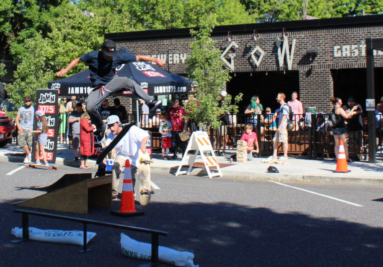 A skateboarder gets some air while a crowd gathered outside Grains of Wrath brewery in downtown Camas watches at a June 14 fundraiser for the Camas-Washougal skatepark.