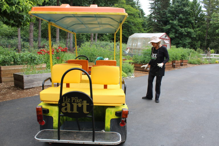 Liz Pike describes the process of turning this golf cart into a “Sunflower Mobile” to transport guests to her farm near Camas.