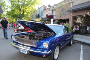 Visitors to the 2019 Camas Car Show check out a blue 1966 Ford Mustang Fastback owned by Sam and Cherrie Melton on Saturday, June 29, in downtown Camas. The Mustang won this year’s “Best in Show” award and will be featured on the 2020 Camas Car Show promotional materials and posters.