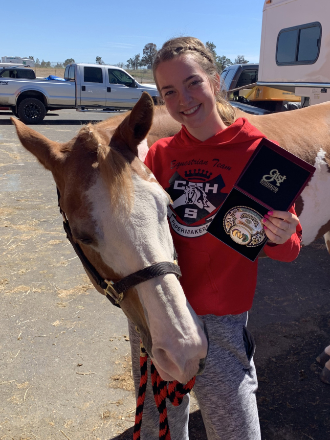 Ashlyn Anderson, who will be a senior at Camas High during the 2019-20 school year, shows her first-place award at the Pacific Northwest Invitational Championship in Redmond, Ore., in June.