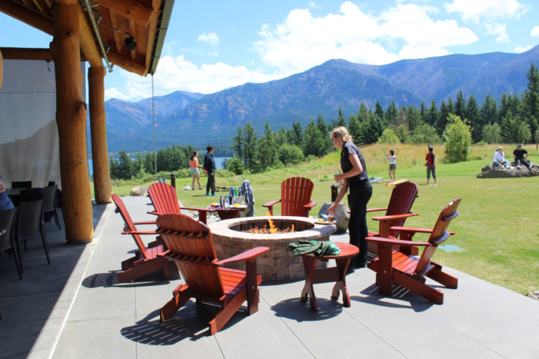 A Skamania Lodge employee clears glasses from tables near one of two outdoor firepits available at the lodge&#039;s new Riverview Pavilion on June 27.