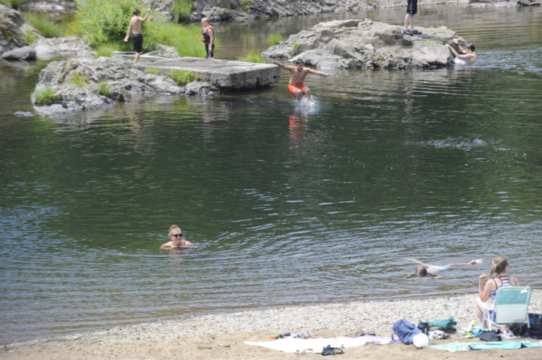 Swimmers return to the Sandy Swimming Hole on July 12, less than three weeks after a fatal hit and run killed a German couple visiting the riverside park.