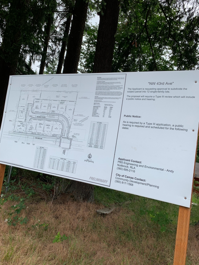 A sign at a planned development of Northwest 43rd Avenue in Camas points to plans for a 12-lot subdivision on a heavily treed lot.
