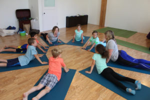 Yoga instructors KC Johnson (third from left) and Jacquie Michelle (right) help their group of "Little Warriors" begin yoga practice at Body Bliss yoga studio in downtown Camas on Friday, July 26. (Photos by Kelly Moyer/Post-Record)