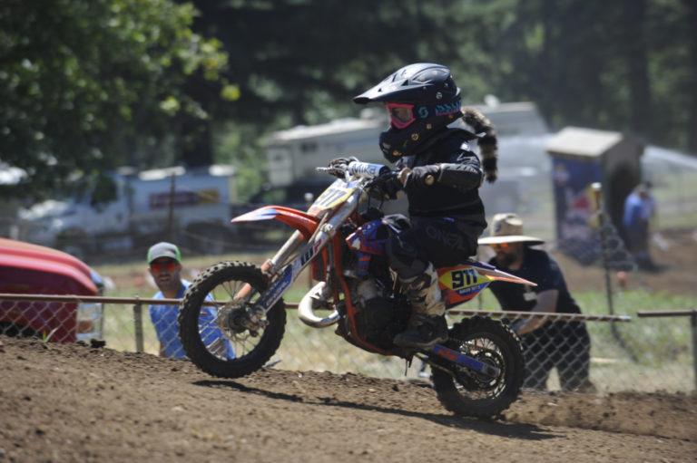 At right, riders start young at Washougal Nationals as a fearless young rider hops back on his 50cc bike and returns to the Washougal MX Park course after falling during a crowded start.