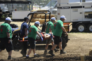 The risks of motorcycle racing are real, and riders and fans support each other when times get tough. An amatuer rider is carried off the Washougal MX Park track by medical crews after a crash during amateur races on Friday, July 26. (Photos by Wayne Havrelly/Post-Record)