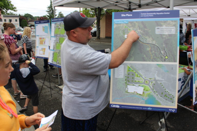A Camas Days attendee examines a map of the proposed Camas Community Aquatics Center on Saturday, July 27.