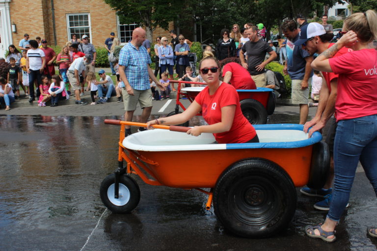 Two teams line up at the starting line for a bathtub race on Saturday, July 27.
