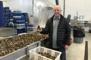 Foods in Season founder John Anderson holds a dried mushroom at one of his warehouses in Washougal in June. 