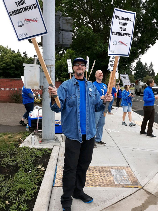 Washington Public Employees Association steward Greg Bergman participates in a rally for Fort Vancouver Regional Library non-management staff wages on July 15.