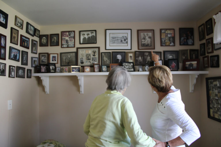 Cay Knapp Smith (left) and Rosemary Knapp (right) point out the many Camas historical figures in Knapp Smith&#039;s family photos on Aug.