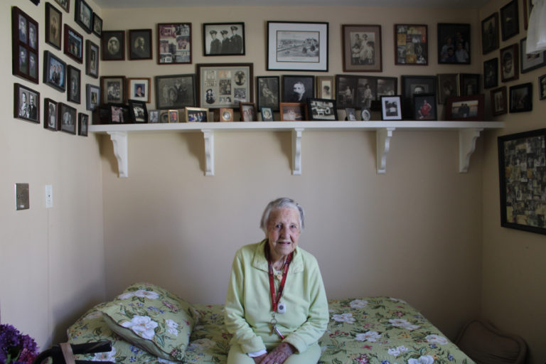 Cay Knapp Smith, a Camas native, sits in her bedroom, surrounded by family photos, on Aug.