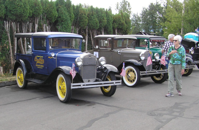 Attendees of the 2018 Heritage Day event at the Two Rivers Heritage Museum in Washougal walk past a Flying Eagle classic car display. This year&#039;s Heritage Day festivities will take place Saturday, Sept.