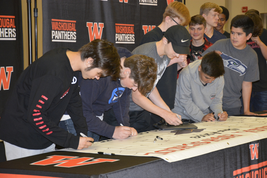 Incoming Washougal High School freshmen sign a "graduation pledge" at an event held Monday, Aug. 26, one day before the official start of the Washougal School District's 2019-20 school year.