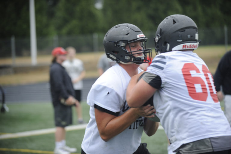 Camas High School lineman Rush Reimer executes a blocking drill at the first practice of the season.