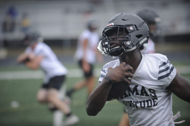 Camas High School running back Jacques Badaloto-Birdsell works on handoff drills during the first day of practice.