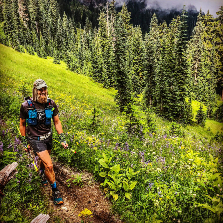 Dave Stinchfield takes in the beauty from a field of wildflowers at mile 98 of the Bigfoot 200 endurance race earlier this month.