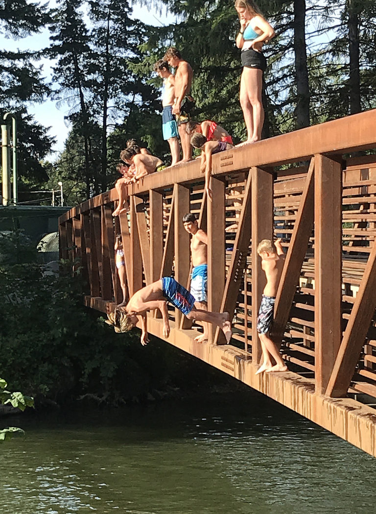 (Photo by Doug Flanagan/Post-Record) 
A group of local children jump off the Northeast Everett Street pedestrian bridge on Aug. 13. A 14-year-old boy who had been jumping off the bridge and swimming in the lake Tuesday died after an apparent drowning.