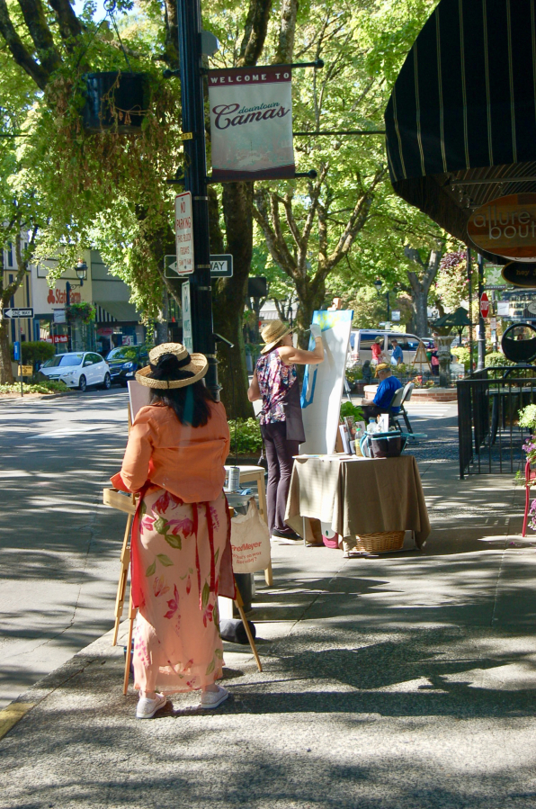 Artists work on plein air paintings in downtown Camas in 2018. This year's outdoor art event is set for Friday.