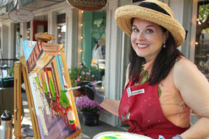 Artist Sarah Bang paints in downtown Camas, near Arktana shoe store, during the 2018   Plein Air event. (Post-Record file photo)