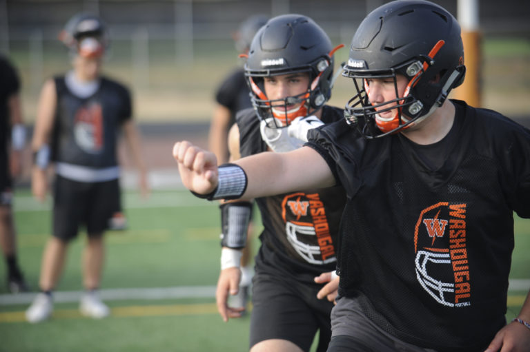 Wayne Havrelly/Post-Record
Washouga High School senior Tommy Liston (right) practices a blocking scheme, making room for senior slot reciever Brevan Bea (center) at a recent practice session. (Wayne Havrelly/Post-Record)