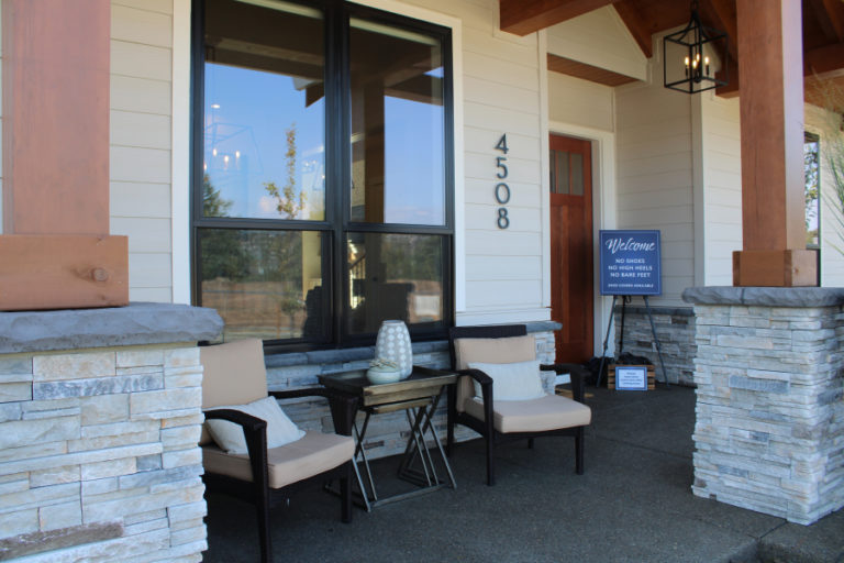 The front porch of the &quot;Mira Verde,&quot; a 4,421-square-foot, five-bedroom, modern farm style home with timber-frame accents, an outdoor living space and full guest bedroom suite with private bathroom by Glavin Homes, welcomes visitors to the 2019 Parade of Homes in Camas&#039; Dawson&#039;s Ridge community.