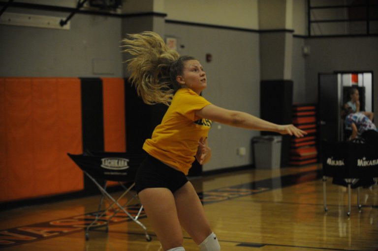 Head Washougal volleyball coach Mallorie Henker (with ball) teaches fundamental techniques to her young team at a recent practice session. Henker coached the Panthers to the 2A District 1 tournament in each of the past two years, but lost 12 varsity players to graduation.