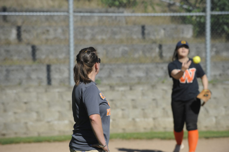 Coach Heather Carver (left) helps a player during a recent practice.