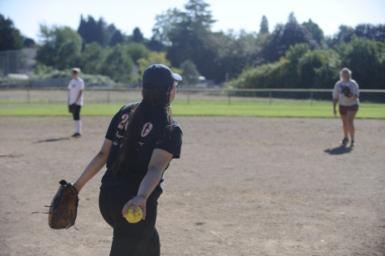 Washougal High School senior Elaina Tauialo practices her slow-pitch technique during a recent practice session.