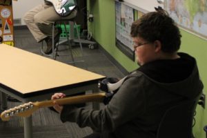 Jemtegaard Middle School teacher Scott Rainey instructs Tristan Simmons during a Club 8 guitar group session on Thursday, Sept. 12 at JMS.