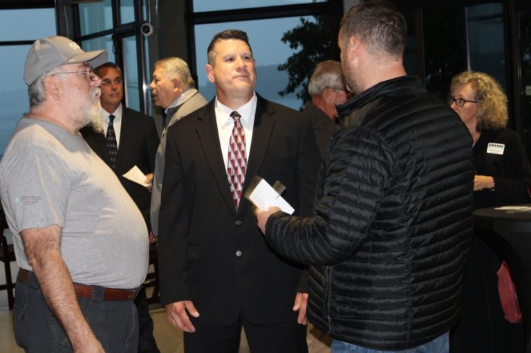 Marc Denney (middle), one of four finalists for the city of Washougal&#039;s police chief position, talks with attendees at a reception Sept.