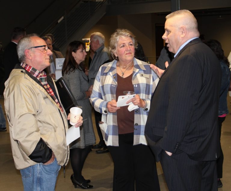 Steve Taylor (right), one of four finalists for the city of Washougal&#039;s police chief position, talks with attendees, including Washougal mayor Molly Coston, at a reception Sept.