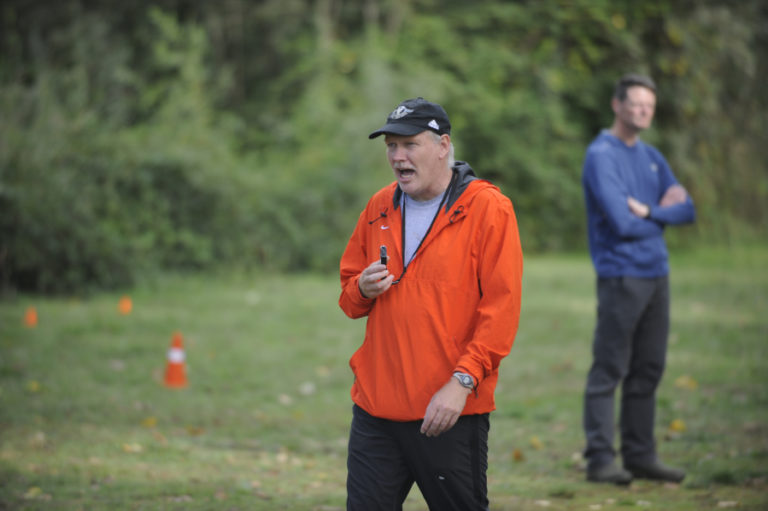 Washougal High School cross country coach Terry Howard shouts advice to his runners during thheir first home meet of the season at Captain William Clark Park on Sept. 18.