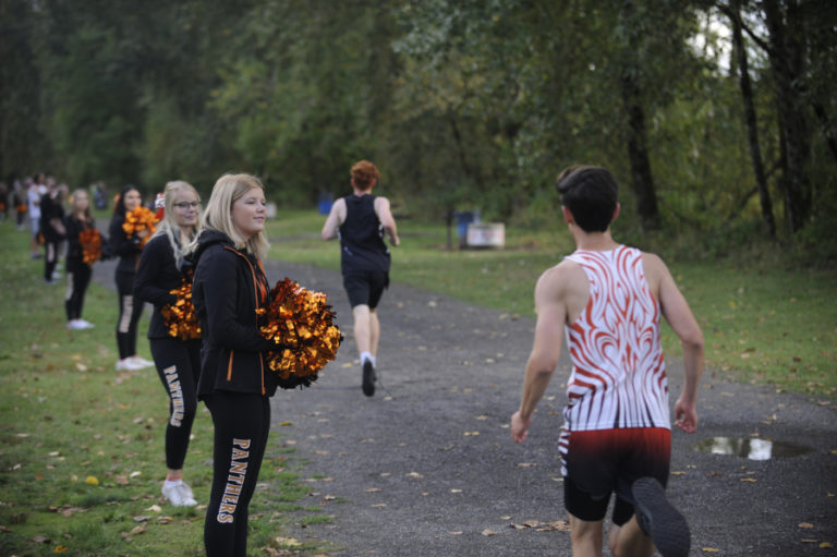 Washougal High School cheerleaders provide inspiration to Panthers runners during a meet against R.A. Long at Captain William Clark Park in Washougal on Sept. 18.