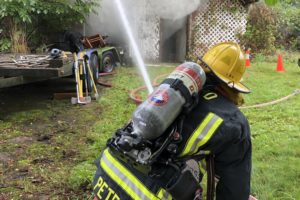Camas-Washougal fire firefighters battle an outbuilding fire on G Street on Wednesday afternoon. (Contributed photo courtesy Camas-Washougal Fire Department)