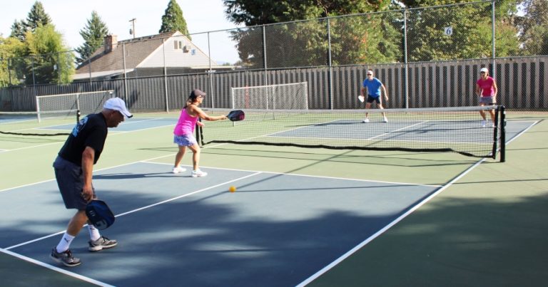 Washougal resident Mike Wolfe (far left) participates in a game of pickleball at Hathaway Park on Sept. 25. Later that day, the courts were named &quot;Wolfe Courts&quot; to honor the efforts of Wolfe and his wife Tawn to create the courts and Washougal&#039;s pickleball community.